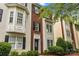 Charming two-story townhome with a brick facade, bay window, and well-maintained landscaping at 9651 Bailey Rd, Cornelius, NC 28031