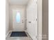 Inviting foyer with a white front door, patterned mat, and closet at 9651 Bailey Rd, Cornelius, NC 28031
