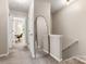 Bright hallway with staircase, mirror, and access to the study at 9651 Bailey Rd, Cornelius, NC 28031