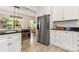 Bright kitchen with stainless steel refrigerator and views to the dining room at 9651 Bailey Rd, Cornelius, NC 28031
