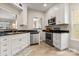 Clean kitchen with stainless steel dishwasher, white cabinetry, and modern appliances at 9651 Bailey Rd, Cornelius, NC 28031