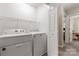 Functional laundry room with modern washer and dryer, and wire shelving at 9651 Bailey Rd, Cornelius, NC 28031