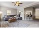 Comfortable living room with ceiling fan, gray sofa, and access to bar with seating at 9651 Bailey Rd, Cornelius, NC 28031