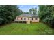 A well-maintained backyard featuring a wooden deck, green grass and privacy fence at 105 Stumpy Creek Rd, Mooresville, NC 28117