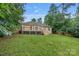 A well-maintained backyard featuring a wooden deck, green grass and privacy fence at 105 Stumpy Creek Rd, Mooresville, NC 28117