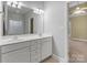 Well-lit bathroom showcasing double vanity, modern fixtures, and a glimpse into the main bedroom at 105 Stumpy Creek Rd, Mooresville, NC 28117