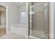 Bright bathroom features a tub and glass shower enclosure, providing a relaxing spa-like experience at 105 Stumpy Creek Rd, Mooresville, NC 28117