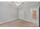 Bedroom with carpet, ceiling fan, double closets, and ensuite access at 105 Stumpy Creek Rd, Mooresville, NC 28117