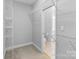 Walk-in closet with white wire shelving, and open access to a bathroom with a toilet at 105 Stumpy Creek Rd, Mooresville, NC 28117