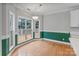 Sunlit dining area with hardwood floors, large windows, and elegant chandelier at 105 Stumpy Creek Rd, Mooresville, NC 28117