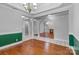 Dining room with hardwood floors, decorative lighting, and views into the living room at 105 Stumpy Creek Rd, Mooresville, NC 28117