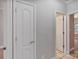Hallway with white trim, and white doors with gold hardware, leading to various rooms at 105 Stumpy Creek Rd, Mooresville, NC 28117