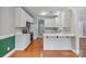Updated kitchen showcasing white cabinets, stainless steel appliances, and a quartz countertop breakfast bar at 105 Stumpy Creek Rd, Mooresville, NC 28117