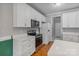Modern kitchen with stainless steel appliances, white cabinetry, and sleek quartz countertops at 105 Stumpy Creek Rd, Mooresville, NC 28117