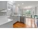 Bright kitchen featuring white cabinets, quartz countertops, stainless steel appliances and hardwood floors at 105 Stumpy Creek Rd, Mooresville, NC 28117