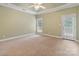 Spacious bedroom with neutral carpeting, private access to the outside and plenty of natural light at 105 Stumpy Creek Rd, Mooresville, NC 28117