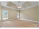 Expansive primary bedroom offering tray ceilings, neutral carpet, and natural light at 105 Stumpy Creek Rd, Mooresville, NC 28117