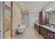 Elegant bathroom with clawfoot tub, stone accent wall, and granite countertops at 117 Walking Horse Trl, Davidson, NC 28036
