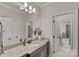 Bathroom with granite countertops, dual sinks, and a large mirror at 117 Walking Horse Trl, Davidson, NC 28036