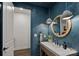 Stylish half bath features a unique round mirror and modern fixtures at 117 Walking Horse Trl, Davidson, NC 28036