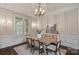 Charming dining room featuring wainscoting, a chandelier, and a rustic wood table at 117 Walking Horse Trl, Davidson, NC 28036