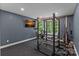 Home gym with exercise equipment, a wall-mounted TV, and a window with natural light at 117 Walking Horse Trl, Davidson, NC 28036