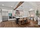 Well-equipped kitchen featuring an island with seating, stainless steel appliances, and dark wood floors at 117 Walking Horse Trl, Davidson, NC 28036
