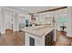 Bright kitchen featuring granite countertops, a large island, and stainless steel appliances at 117 Walking Horse Trl, Davidson, NC 28036
