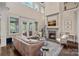 Bright living room with fireplace, large windows, and access to the outdoors at 117 Walking Horse Trl, Davidson, NC 28036