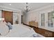 Airy main bedroom featuring a sliding barn door, neutral colors and beautiful hardwood floors at 117 Walking Horse Trl, Davidson, NC 28036