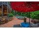 Inviting pool area with a stone-trimmed spa and lounge chairs, shaded by a large red umbrella at 117 Walking Horse Trl, Davidson, NC 28036
