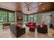 Beautiful screened porch featuring stone fireplace, wood ceiling, and comfortable seating at 117 Walking Horse Trl, Davidson, NC 28036
