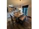 Well-lit dining area with a table set for dinner, connecting to the kitchen and living room at 13219 Asbury Chapel Rd, Huntersville, NC 28078