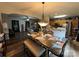 Open concept dining area with a dining table, a view into the living room and kitchen space at 13219 Asbury Chapel Rd, Huntersville, NC 28078