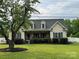 Charming single-Gathering home with manicured lawn, dormer windows, and welcoming covered porch at 13219 Asbury Chapel Rd, Huntersville, NC 28078