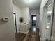 Hallway with hardwood flooring that leads to doorways and a modern thermostat for climate control at 13219 Asbury Chapel Rd, Huntersville, NC 28078