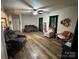 Spacious living room with hardwood floors and comfortable seating, illuminated by a ceiling fan at 13219 Asbury Chapel Rd, Huntersville, NC 28078