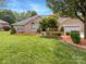 Charming brick home featuring a well-manicured lawn and attached garage at 1326 Crown Ridge Dr, Fort Mill, SC 29708