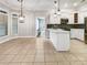 Open-concept kitchen with tile floor, white cabinets and granite countertop at 1326 Crown Ridge Dr, Fort Mill, SC 29708