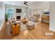 Bright, staged living room with hardwood floors, fireplace, and a seamless flow to the dining area at 1326 Crown Ridge Dr, Fort Mill, SC 29708