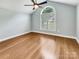 Airy main bedroom featuring a vaulted ceiling, hardwood floors, and a large arched window at 1326 Crown Ridge Dr, Fort Mill, SC 29708
