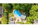Aerial view of the kidney-shaped swimming pool, backyard, cabana, and lush landscaping at 1522 12Th Fairway Nw Dr, Concord, NC 28027