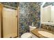 Stylish bathroom featuring a shower, granite vanity, and floral wallpaper at 1522 12Th Fairway Nw Dr, Concord, NC 28027