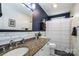 Bathroom with a marble counter, white cabinets, modern sink, and tub with shower at 1522 12Th Fairway Nw Dr, Concord, NC 28027