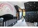This stylish bedroom features a custom rainbow mural and a small play area at 1522 12Th Fairway Nw Dr, Concord, NC 28027