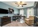 This bedroom features a ceiling fan, large desk, and neutral paint at 1522 12Th Fairway Nw Dr, Concord, NC 28027