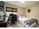 This carpeted bedroom features a cozy bed, desk area, and window at 1522 12Th Fairway Nw Dr, Concord, NC 28027