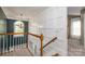 Second floor hallway featuring white trim, a window for natural light, and a view of the staircase at 1522 12Th Fairway Nw Dr, Concord, NC 28027