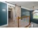 A carpeted hallway features a decorative barn door and natural light at 1522 12Th Fairway Nw Dr, Concord, NC 28027