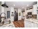 Gourmet kitchen featuring stainless steel appliances, granite countertops, white cabinetry, and modern fixtures at 1522 12Th Fairway Nw Dr, Concord, NC 28027